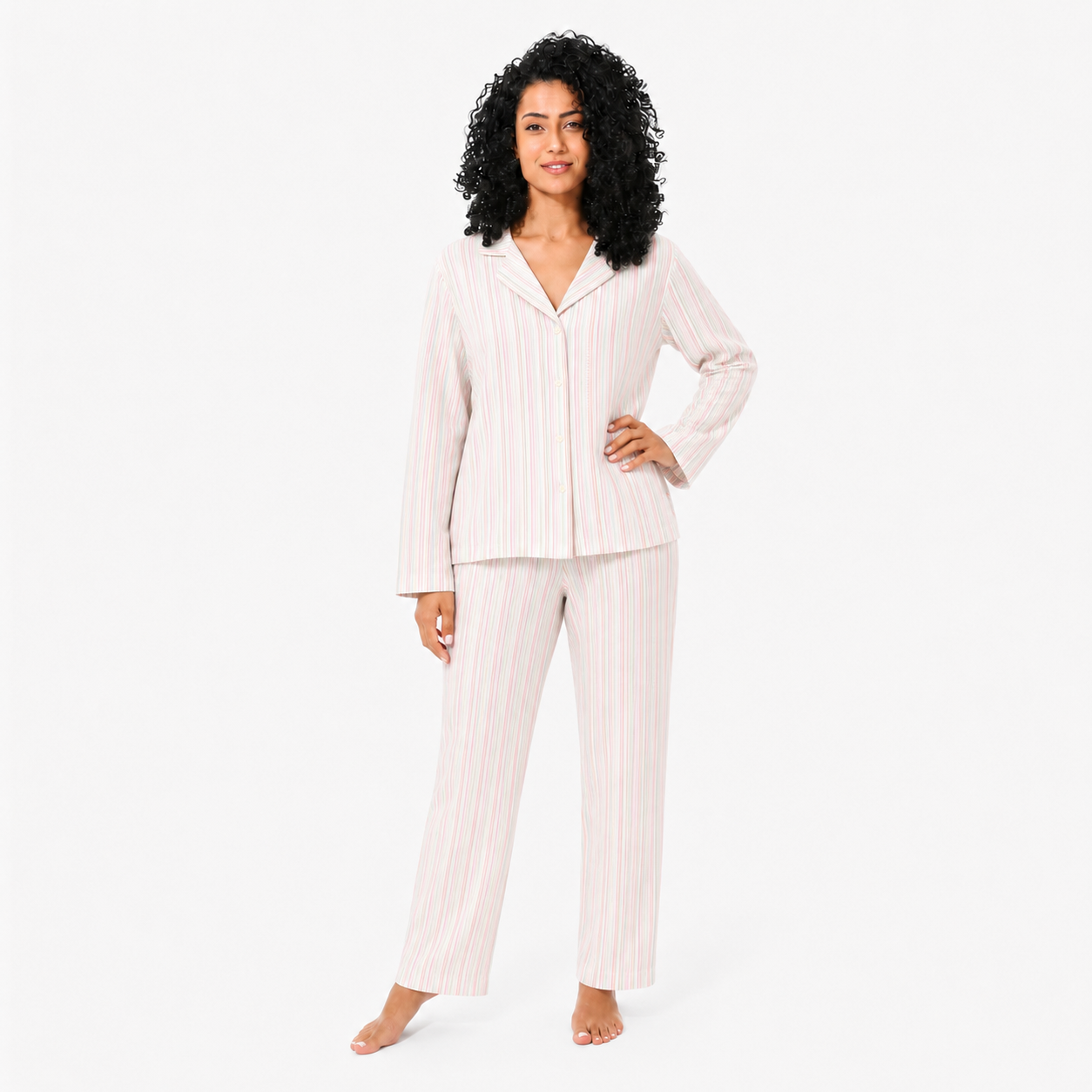 Woman wearing a striped pajama set on a white background