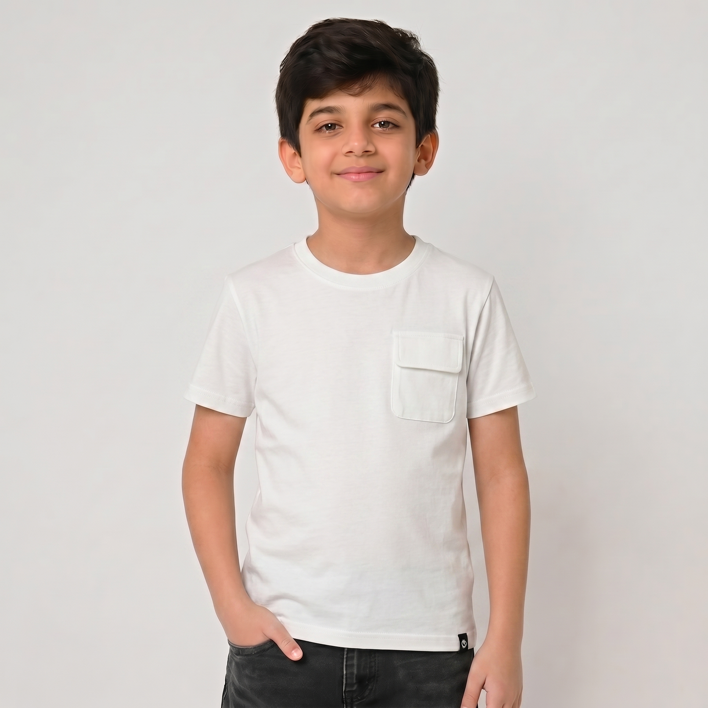 Young boy wearing a white t-shirt against a plain background