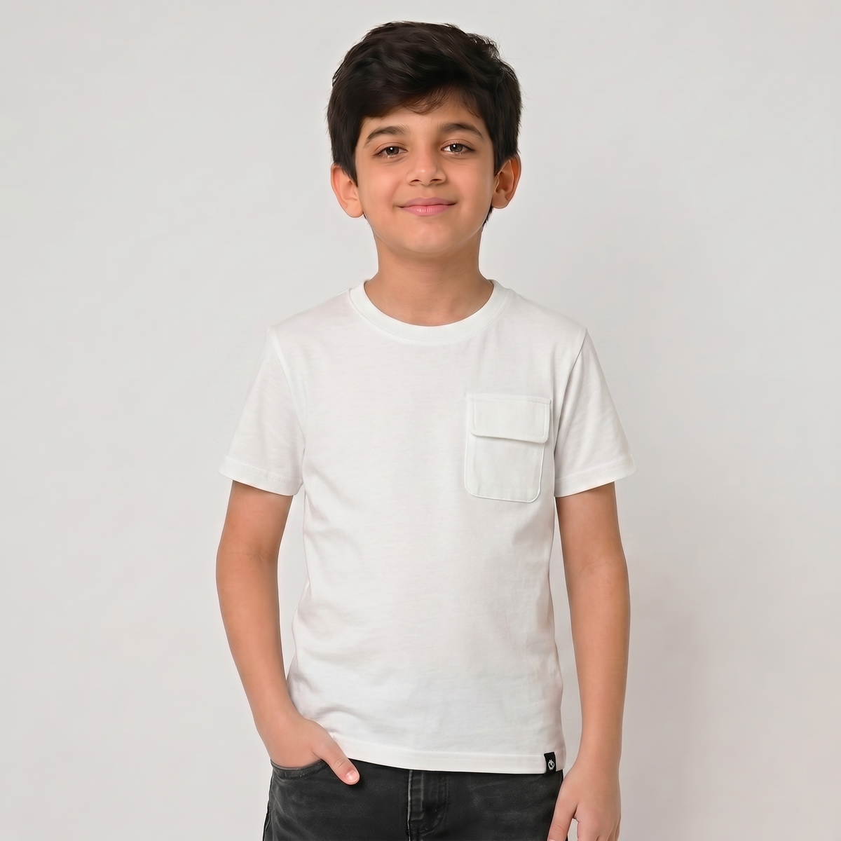 Young boy wearing a white t-shirt against a plain background