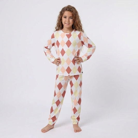 Child wearing a patterned pajama set on a white background