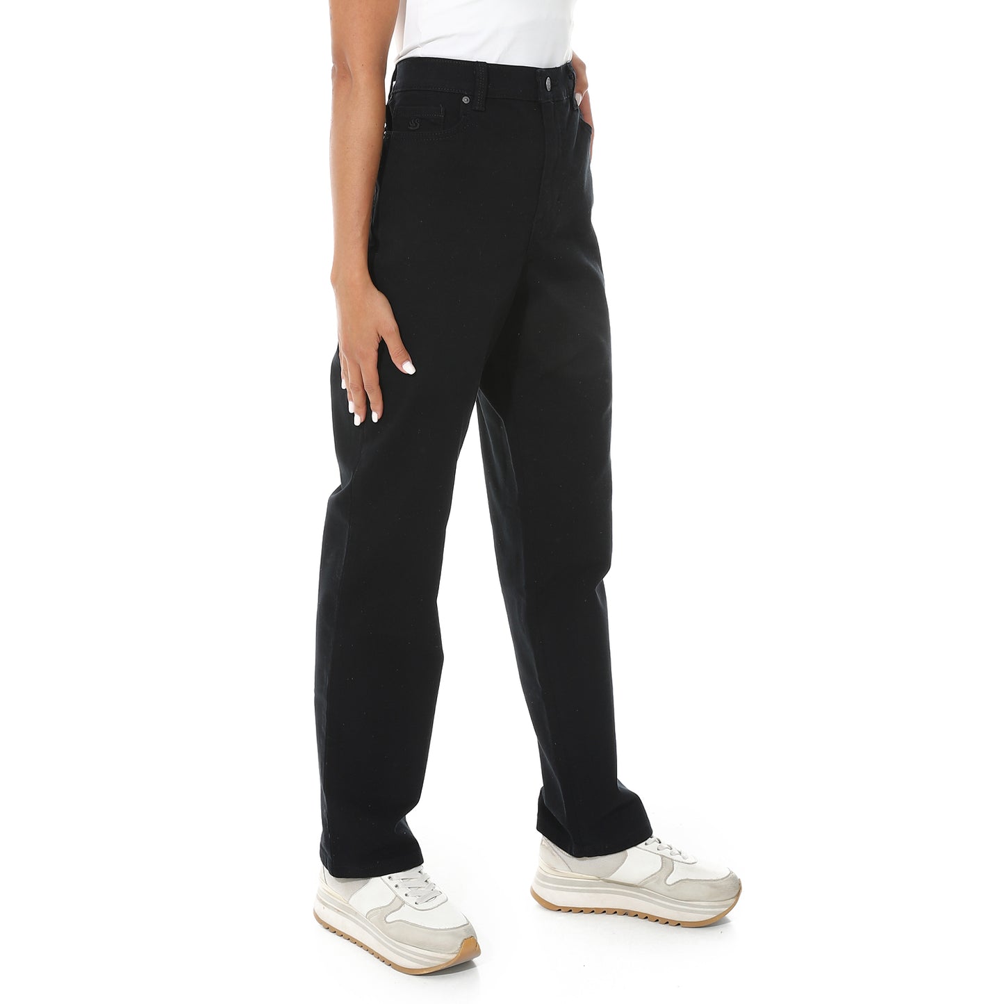 Person wearing black pants and white sneakers on a white background