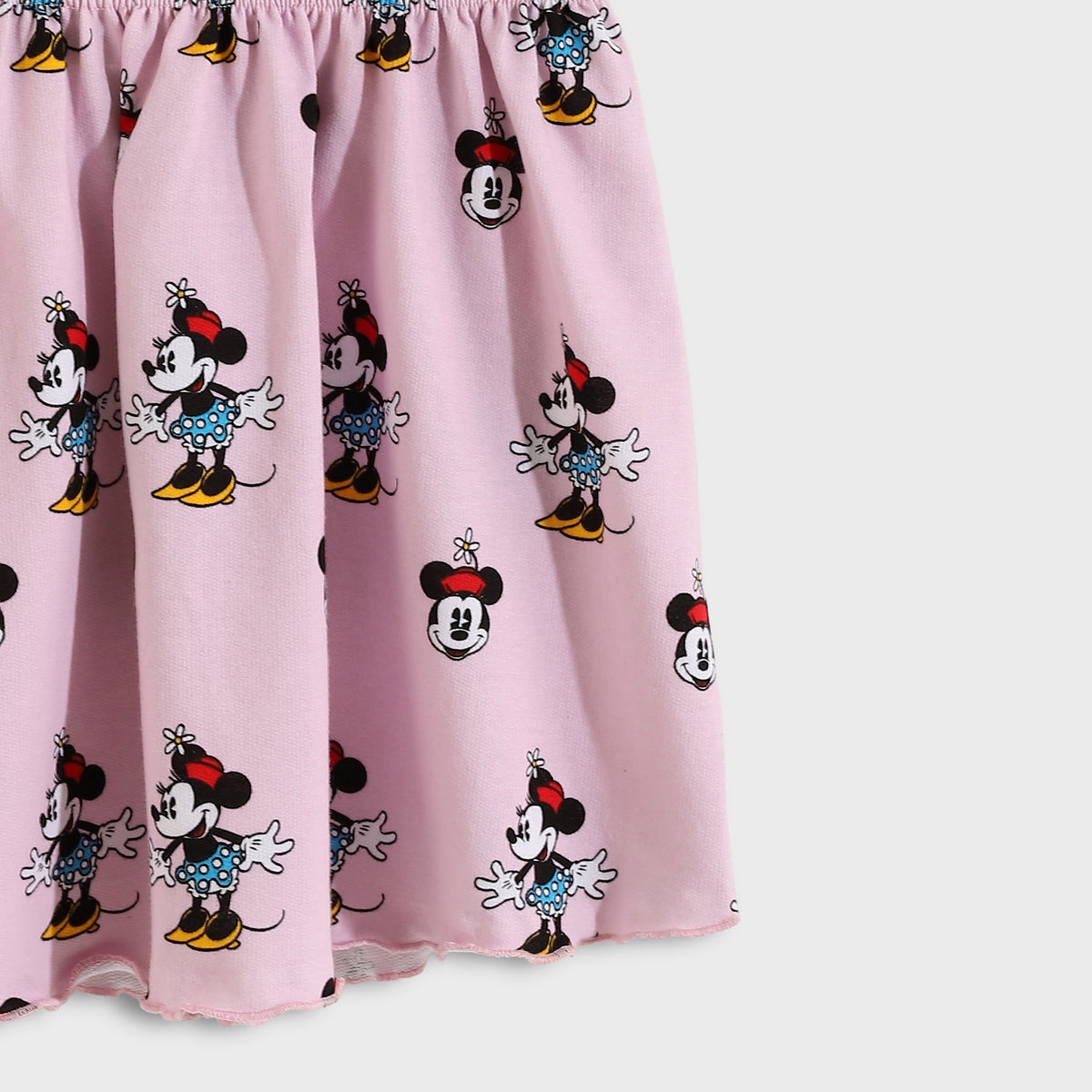 Pink curtain with Minnie Mouse pattern on a white background