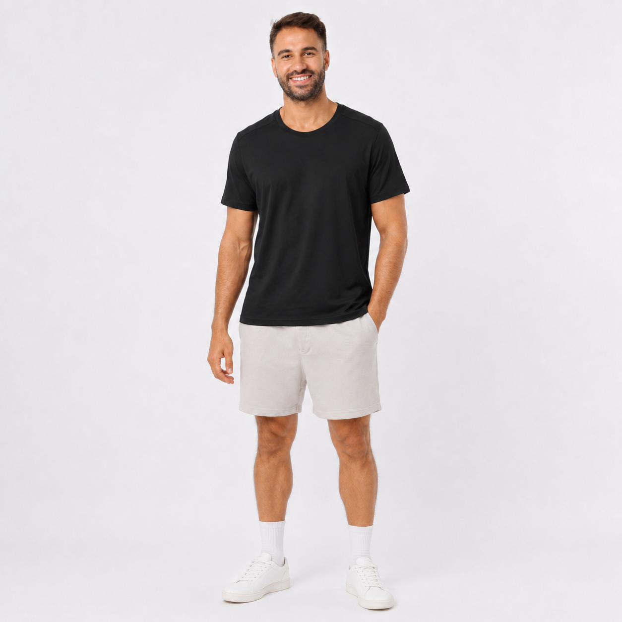 Man wearing a BLACK plain polyester short-sleeve T-shirt, angled view