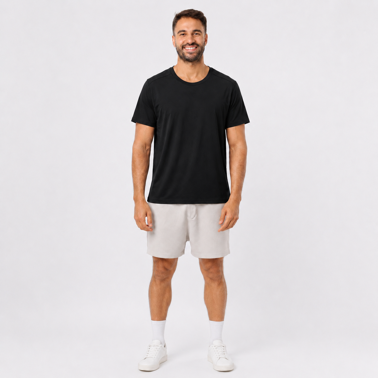 Man wearing a BLACK plain polyester short-sleeve T-shirt, front view