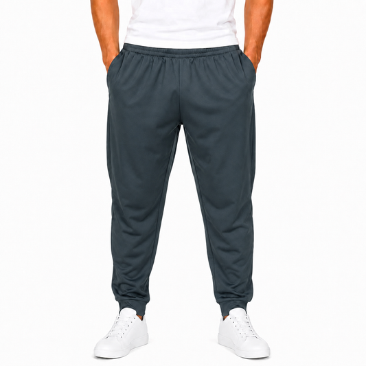 Men's dark gray polyester jogger pants on model with elastic waist and cuffed hems