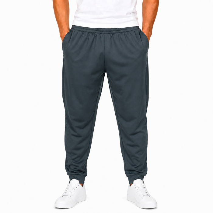 Men's dark gray polyester jogger pants on model with elastic waist and cuffed hems
