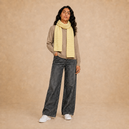 Model wearing women's textured knit scarf in yellow