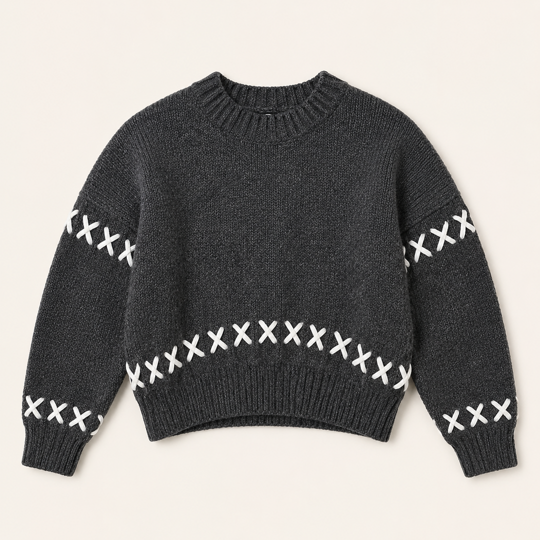 Women dark gray knit crew neck pullover with white cross-stitch detail flat lay