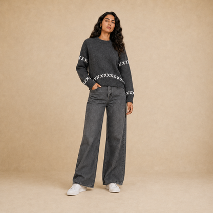 Women dark gray knit crew neck pullover with white cross-stitch detail on model
