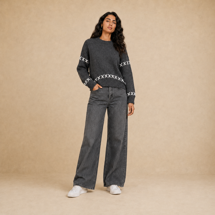 Women dark gray knit crew neck pullover with white cross-stitch detail on model