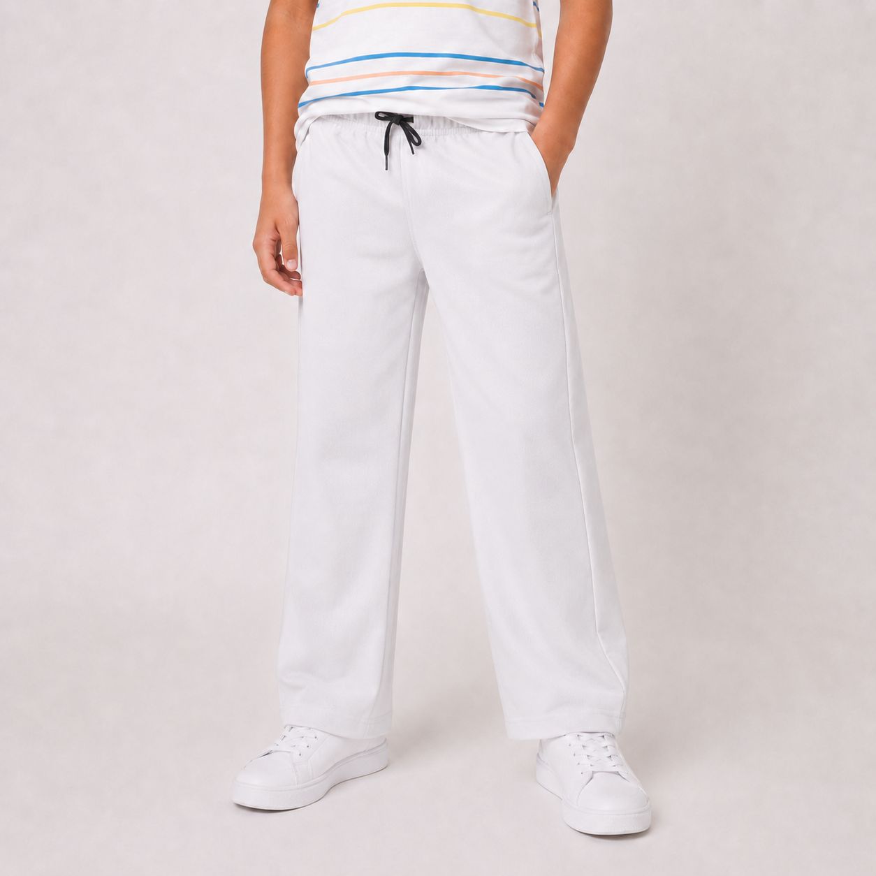 Boy wearing SILVER wide-leg drawstring pants, front view