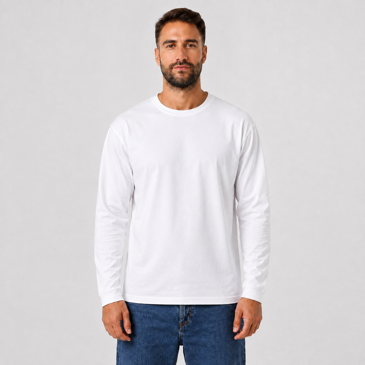 Man wearing a WHITE plain long-sleeve crew-neck T-shirt, front view