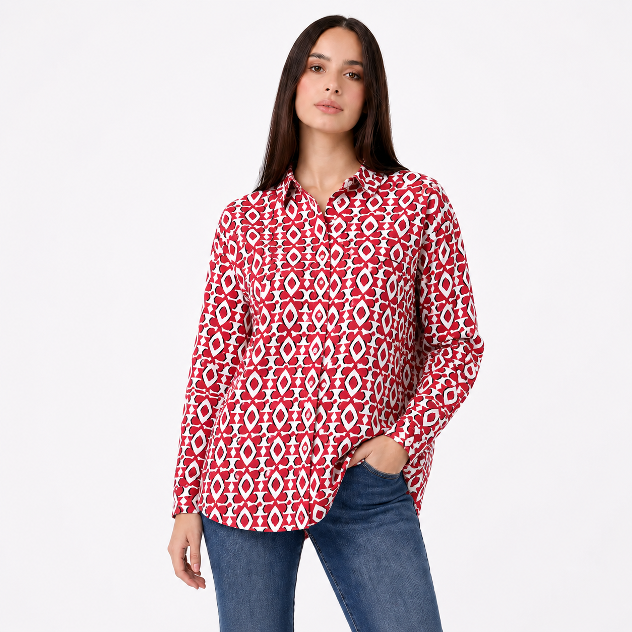 Woman wearing a red and white patterned shirt with blue jeans on a white background