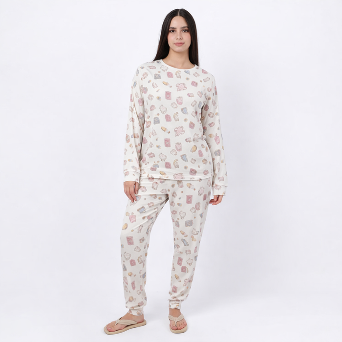 Woman wearing a patterned pajama set on a white background
