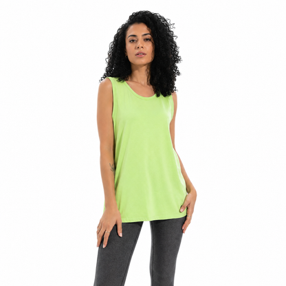 A woman with curly black hair wearing a bright neon yellow-green sleeveless tank top and dark gray leggings, standing against a plain white background.