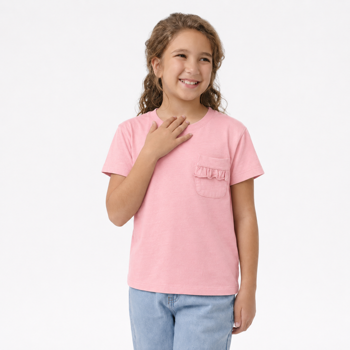 Young girl wearing a pink t-shirt with a pocket on a white background