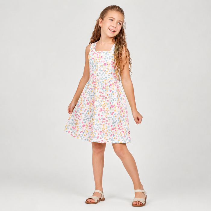 Young girl wearing a floral dress on a white background