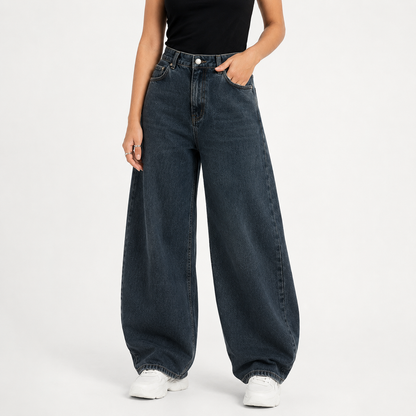 Person wearing wide-leg jeans on a white background
