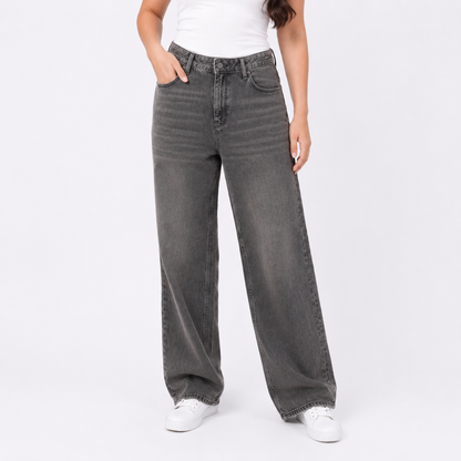 Person wearing gray wide-leg jeans on a white background