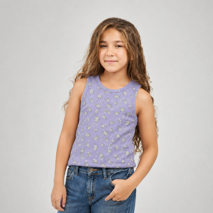 Young girl wearing a purple sleeveless top with floral pattern and blue jeans on a gray background