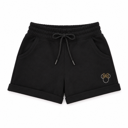 Black shorts with a decorative emblem on a white background