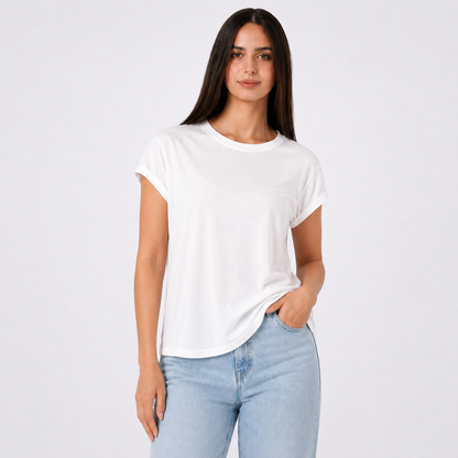 Woman wearing a white t-shirt and light blue jeans on a plain background