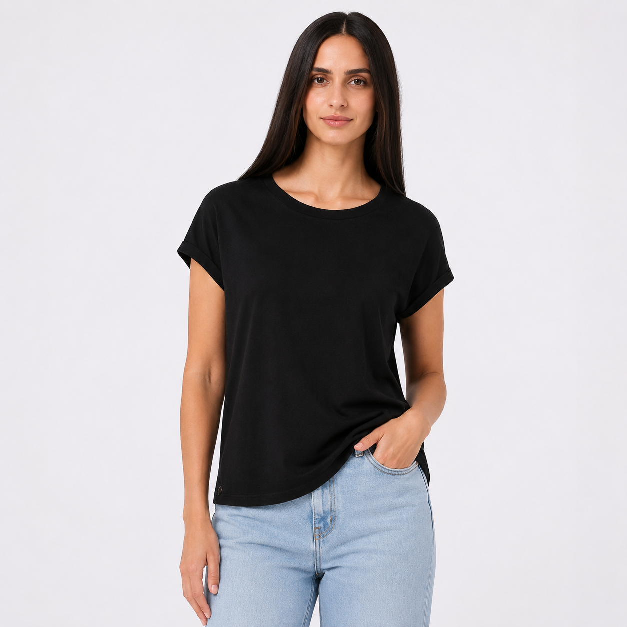 Woman wearing a black t-shirt and light blue jeans on a white background