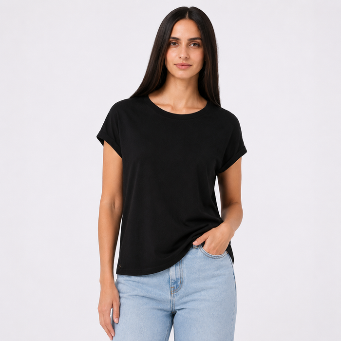 Woman wearing a black t-shirt and light blue jeans on a white background