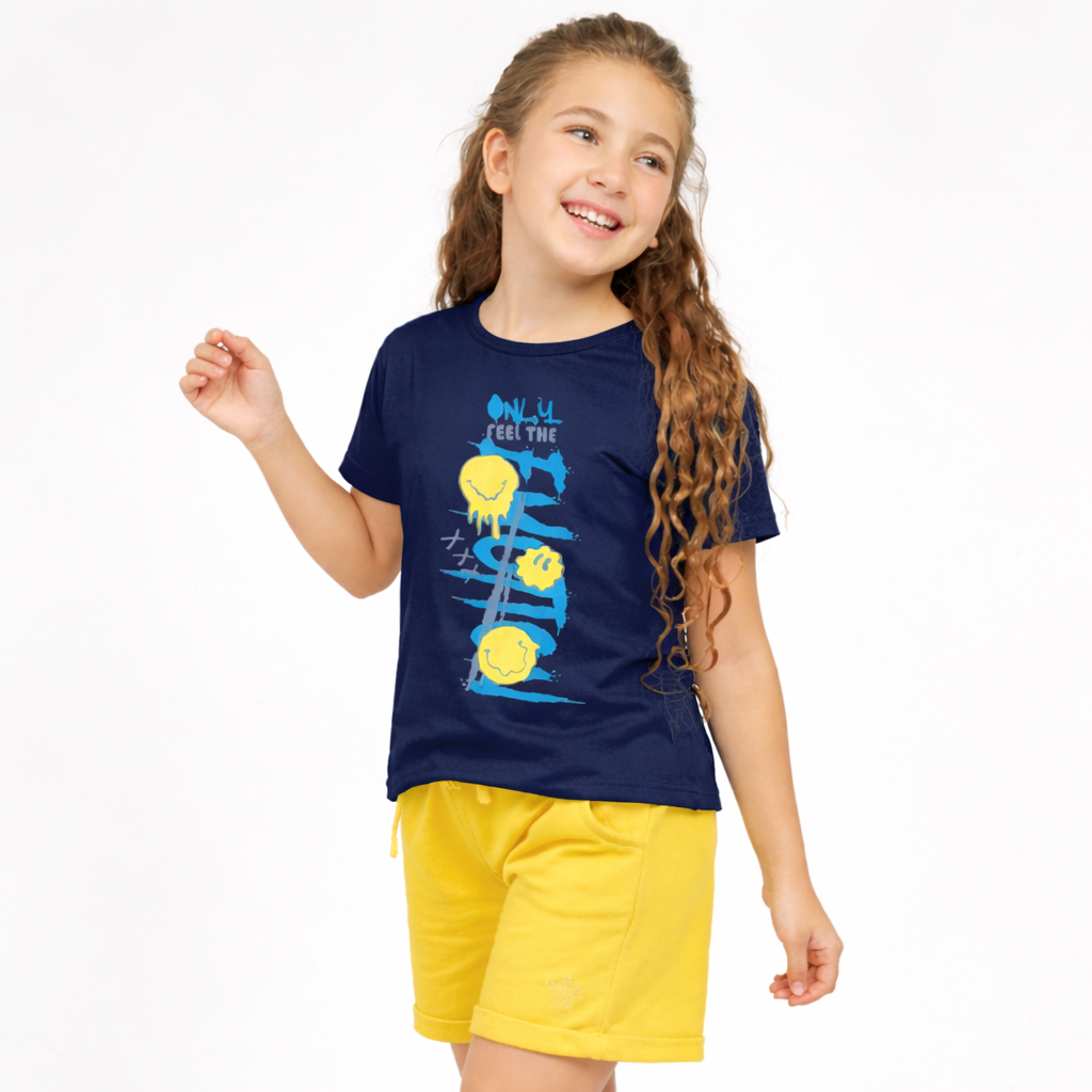 Young girl wearing a navy blue t-shirt with a graphic design and yellow shorts on a white background