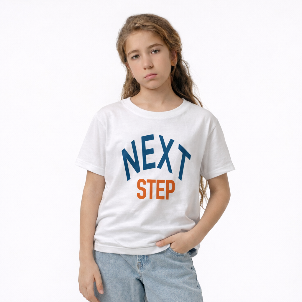 Young girl wearing a white t-shirt with 'NEXT STEP' text on a white background