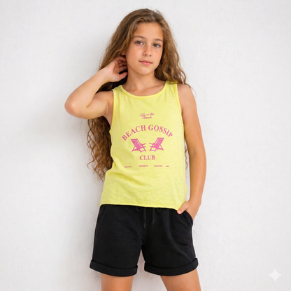 Girl wearing a yellow tank top with 'Beach Gossip Club' text and black shorts on a white background