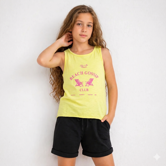 Girl wearing a yellow tank top with 'Beach Gossip Club' text and black shorts on a white background