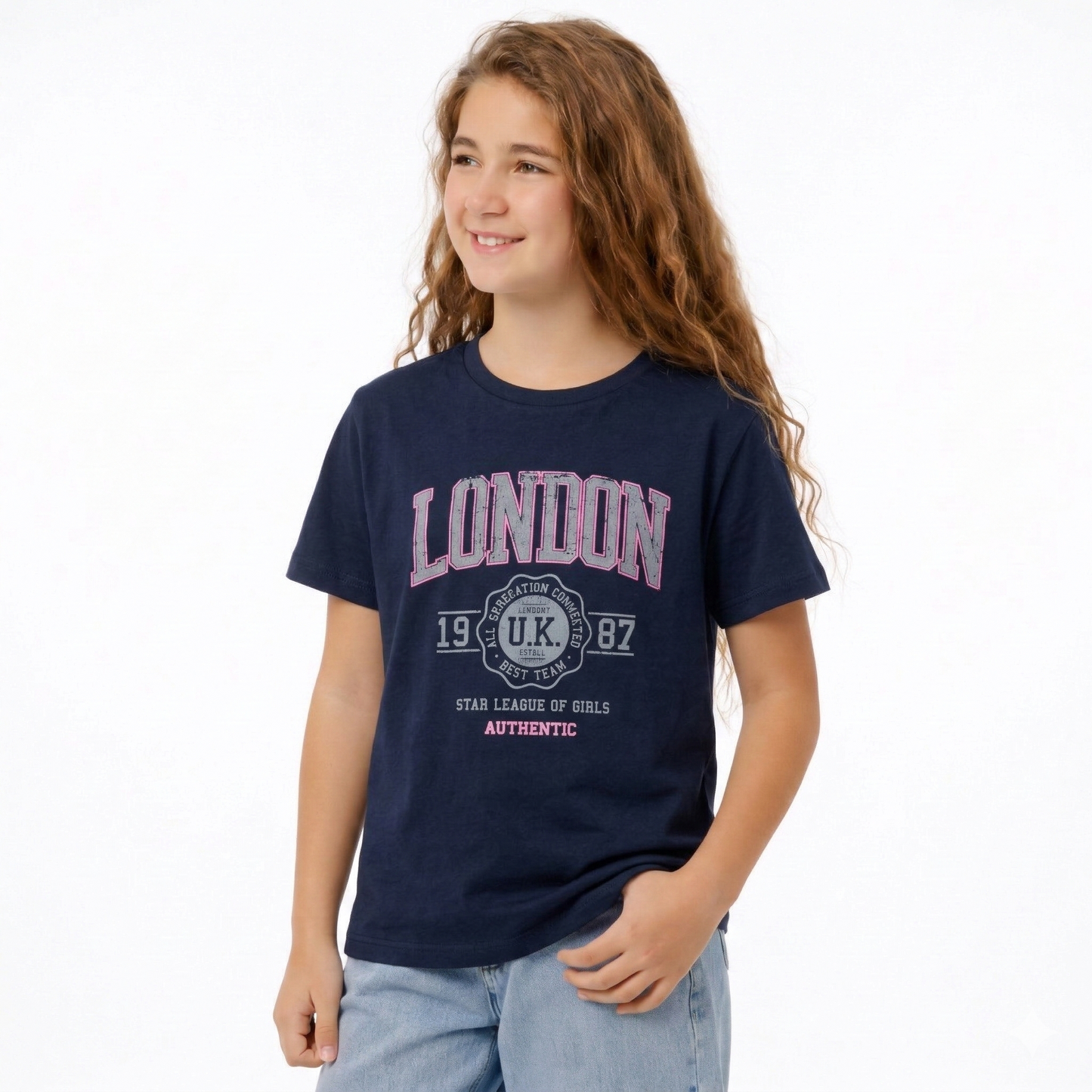 Young girl wearing a navy blue t-shirt with 'London' print on a white background