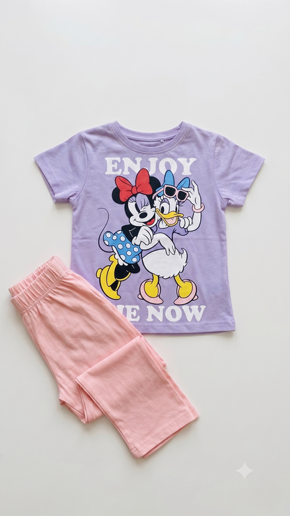 Children's t-shirt with cartoon characters and pink pants on a light gray background