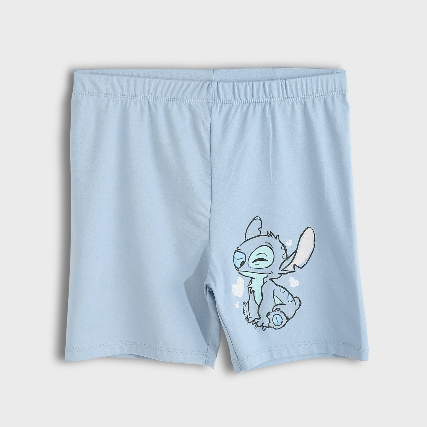 Light blue boy's swim trunks featuring a cartoon graphic of Stitch on the left leg, displayed against a neutral light gray background.