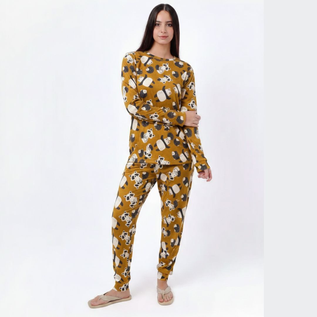 Woman wearing a mustard yellow pajama set with dog pattern on a white background