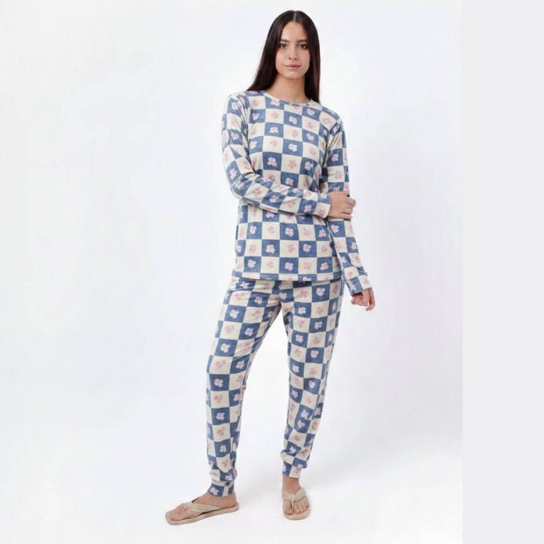 Woman wearing a blue and white checkered pajama set on a white background