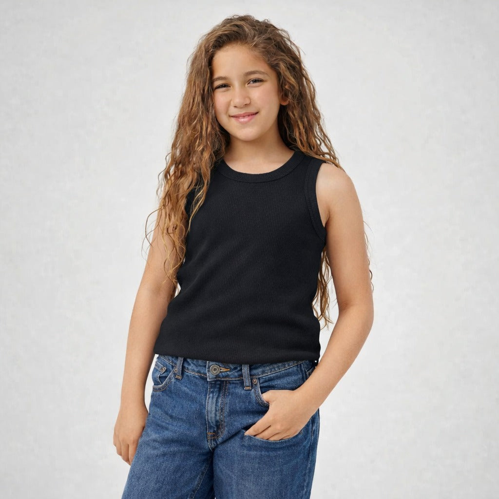 Young girl wearing a black sleeveless top and blue jeans on a white background