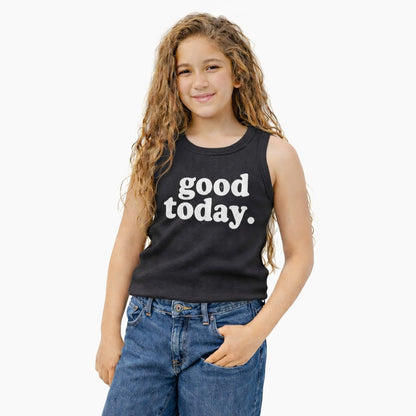 Young girl wearing a black sleeveless shirt with 'good today.' text on a white background
