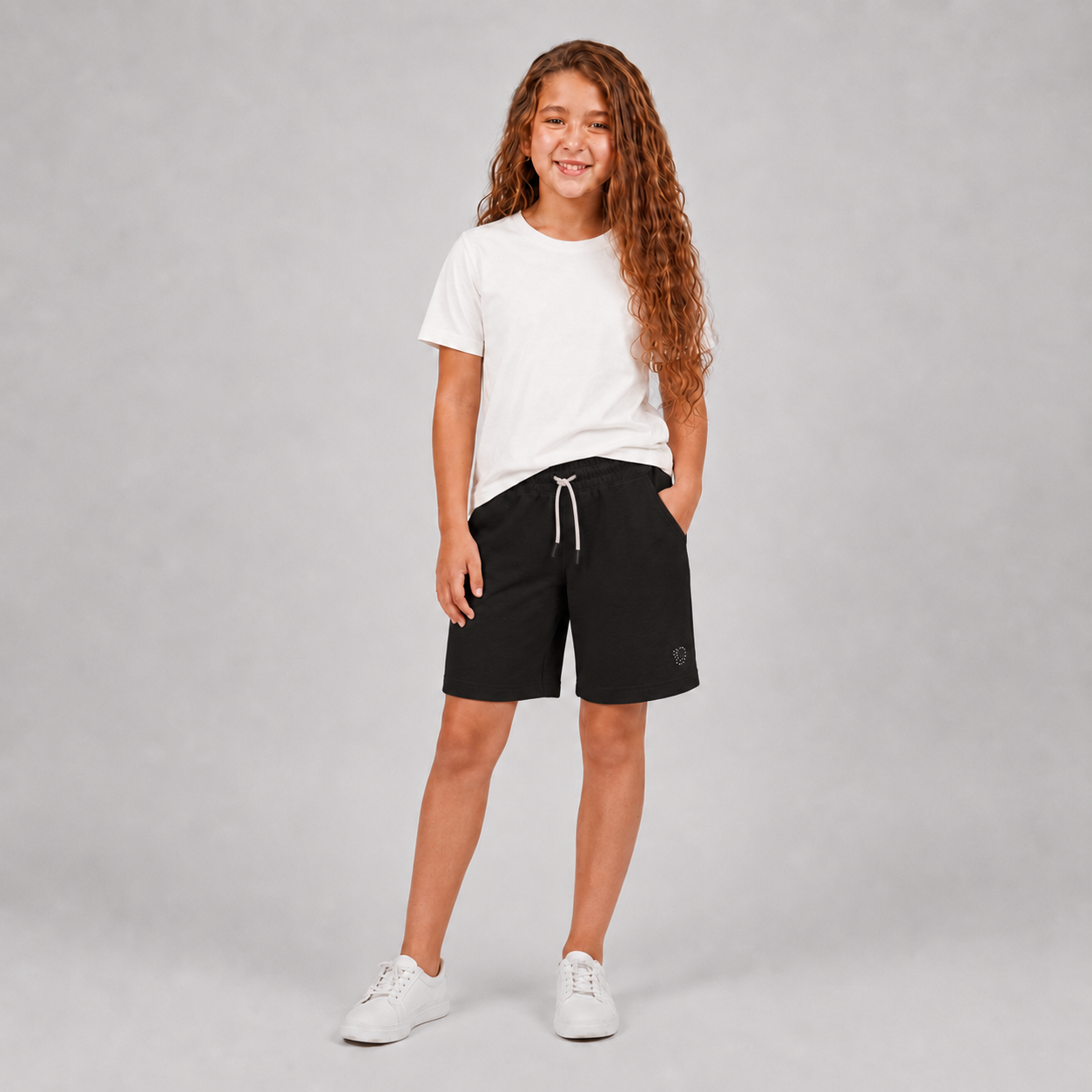 Girls black drawstring shorts with rhinestone detail on model