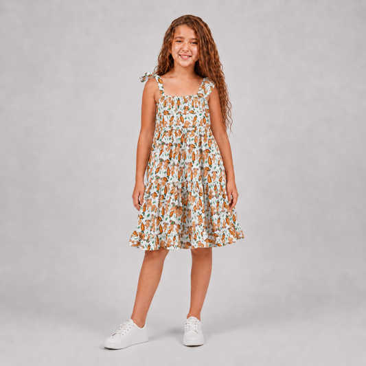 Girl wearing white bunny print tiered dress with asymmetric shoulder details