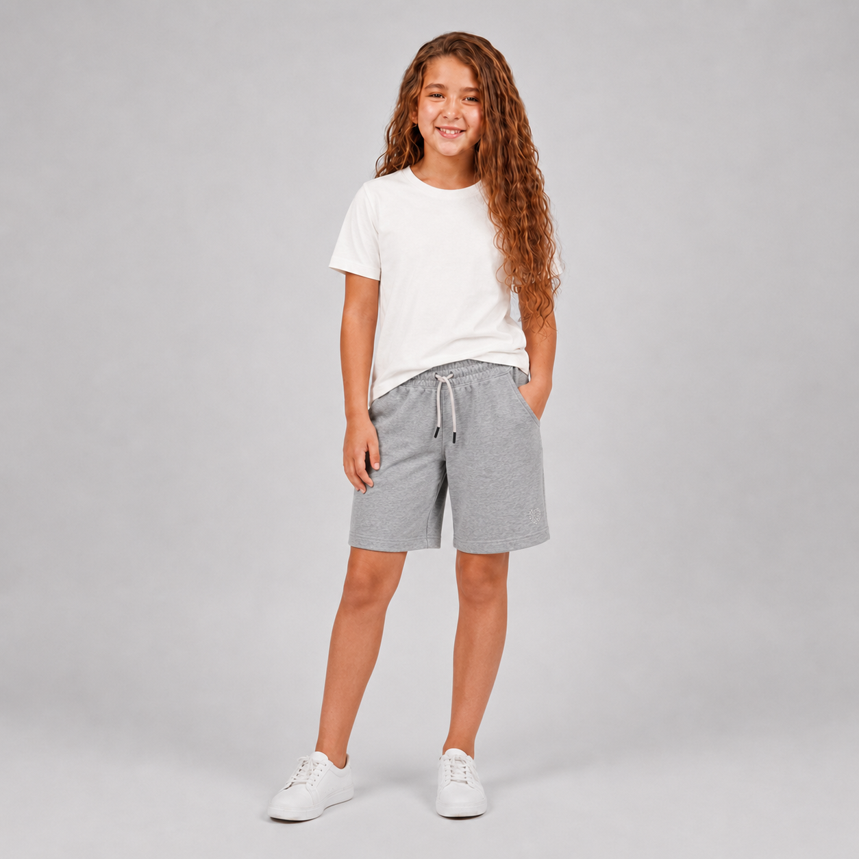 Girls plain cream crew-neck T-shirt styled with light gray shorts