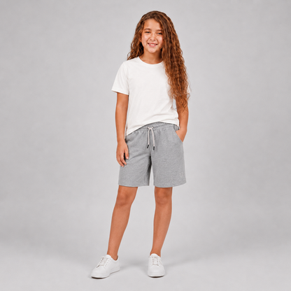 Girls plain cream crew-neck T-shirt styled with light gray shorts